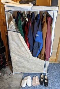 lot 335 image: Fabric Wardrobe with Mens Coats and Womens Slippers Worthington, Free Country, Dockers and More