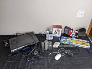 lot 299 image: Assortment of Electronics EZ Eyes Keyboard, Verizon Phone, Apple Mouse, Remotes and More