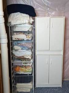 lot 324 image: Wire Basket Organizer and 4-Door Cabinet with Blankets, Towels and More