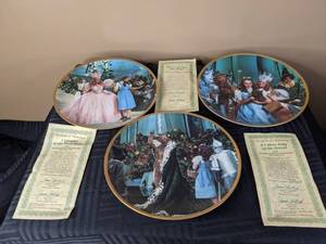 lot 312 image: A Glimpse of The Munchkins 4499F, If I Were King of The Forest 3396E and Theres No Place Like Home 0309E From The Wizard of Oz Commemorative Plate Collection By The Hamilton Collection