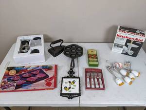 lot 48 image: Assortment of Kitchen Accessories Defrost Plate, Kitchen Aid Grinder Attachment, Williams Sonoma Apple Harvest Spreaders, Whiskies and More