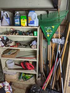 lot 122 image: 5-Shelf Metal Tool Shelf with Yard Tools Craftsman Hedger, Lawn Rakes, Shovels, Roof Snow Rake, Shears and More