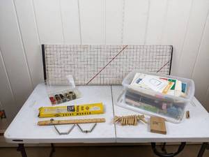 lot 81 image: Assortment of Sewing Supplies Needles, Pins, Elastic, String, Crafters Measuring Tape, Sewing Patterns, Buttons, Craft Mat and More
