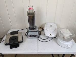lot 54 image: Vintage Vita-Mix 3600 The Bread Maker, Cuisinart Waffle Maker, George Foreman Lean Mean Fat Grilling Machine and Black & Decker Handy SteamerRice Cooker