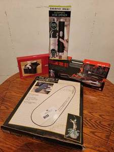 lot 50 image: Everything You Need- Sharper Image Automatic Wine Opener, Armrest Organizer, Golf Bag Travel Cover ($160 Value)