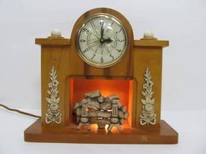 lot 72 image: Mid Century Lighted Fireplace Clock by Lanshire