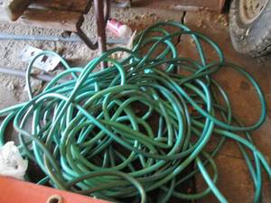 lot 182 image: Heap of heavy duty garden hose(s). ...