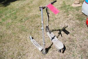 lot 16 image: (2) ride on scooters. One is a razo...