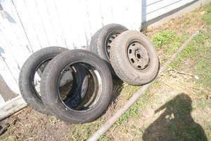 lot 40 image: Lot of 4 tires 2 with rims. Sizes i...