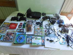 lot 134 image: Playstation 2 & PS 1 with controllers for various systems, memory cards for playstation 2, video games for various systems, Yu-Gi-Oh trading cards and more