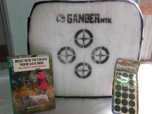 lot 149 image: Gander mountain bow target, dog book & target stickers