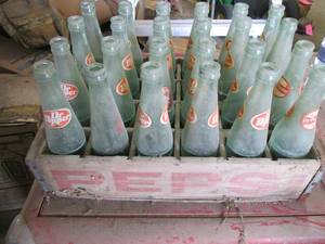 24 Dr Pepper bottles in a wood Peps...
