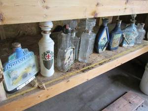 Contents of shelf, mostly decanters...