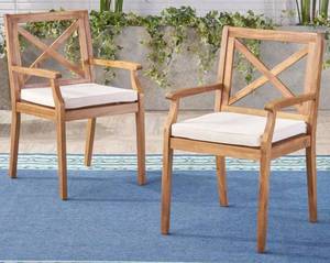 lot 545 image: Noble House Perla Teak Brown Cross Back Wood Outdoor Dining Chairs with Cream Cushions (2-Pack)