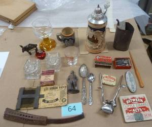 An interesting variety lot, Old small oil can with a tiny spout, a metal war hero figure, Schwinn bicycle plate, cigar box,  Jim Beam toothpick holders, old horn knife, advertising items, box of Esterbrook fountain ink pen tips