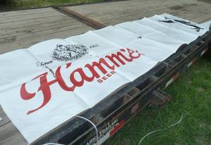 2 large vinyl Hamms Beer signs in poor condition one is 32 inches x 9.5 feet long, the other 21 x 81 inches