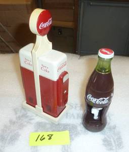 Coca Cola salt and pepper shakers shaped like pop machines (about 6 inches tall) and a wind up coke bottle and the bear spins around