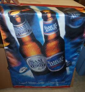 Like new Samuel Adams beer banner, shiny fabric, double sided with same image on both sides, hangs from a wood dowel, measures 24x36