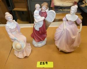 3 lady figurines, the one on the right is musical