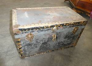 Doll trunk full of antique clothing and a baby quilt