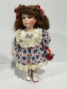lot 13 image: Porcelain Apple Theme Doll with Stand