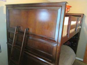 Wood bunk bed with ladder and displ...