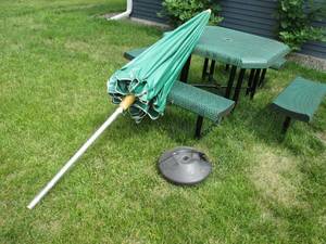 Metal picnic table with umbrella to...