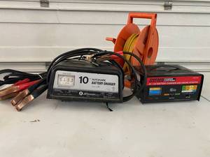 lot 74 image: Two Battery Chargers, cables and cord reel