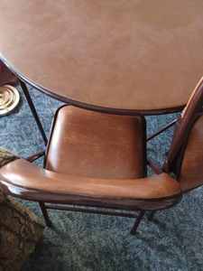 lot 40 image: Brown Vinyl Top Card Table with 4-Padded Folding Chairs, 2-Chairs are in Good Condition, 2-Chairs have torn seats