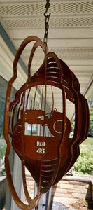 lot 90 image: Pair of Copper-Colored Hanging Metal Wind Spinners of Allis-Chalmers WD 45, 11-inches Round