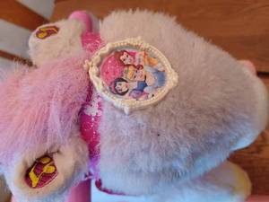 lot 149 image: Small Disney Rocking Horse, Princess Crown, and a Plush Frog