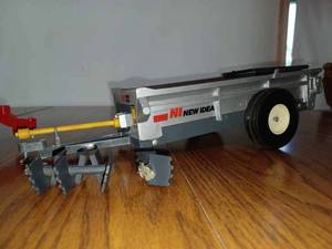 lot 200 image: 116th Scale Detailed New Idea 3622 Manure Spreader (Beater is Broken) Heavy Toy, and a 116th Scale New Holland Haybine