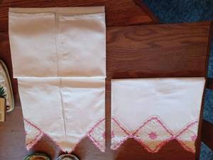 lot 228 image: Vintage Pair of Embroidered and Pinned - Appear to be 32-inch Long Pillow Cases, a Doilies Pot Holder, New Home Collection Pair of
