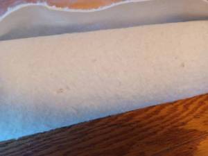 lot 232 image: Roll of White Felt Material 54-inches wide, the end of the Roll Measures 2.5 inches around, Length Unknown