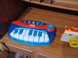 lot 297 image: Little Tikes Piano, Fisher-Price Picture Story Camera, and a School House Pull-Toy