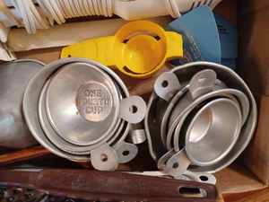 lot 350 image: Box of Kitchen Utencils - Assorted Measuring Cups, Electric Carving Knife with One Blade, Metal Funnel, and More