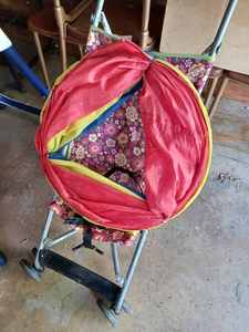 lot 409 image: Cosco Folding Baby Stroller, a Crawl-Through Tube with Triangle Opening, and an Inflatable Tube for Swimming