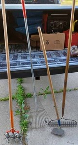 lot 425 image: Four Lawn and Garden Tools Garden Weasel, Garden Hoe, Garden Rake, and a Leaf Rake