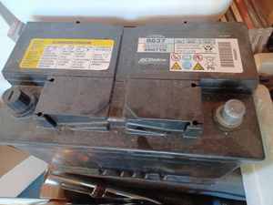 lot 497 image: AC Delco 8637 12-Volt Battery - Stored on Carpeted Wood Steps - Condition Unknown