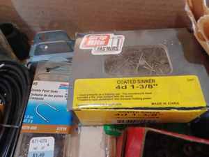 lot 511 image: Two Boxes of Hardware Electronics Cords, Audio-Visual Cords, Garden Hose Spray Nozzle, and a Box Coated Sinker Nails
