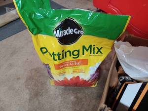 lot 515 image: Nearly a One Cu. ft. Bag of Peat Moss and a Half a Bag of Miracle-Gro Potting Mix
