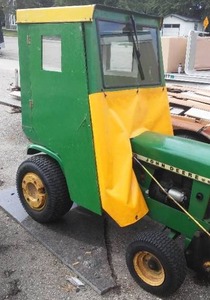 lot 4 image: John Deere 140 Garden Tractor, Cab, Blower, Mower, Chains, Weights & Hydraulics.