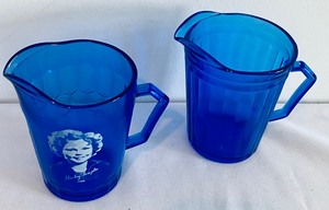 lot 210 image: Two Vintage Cobalt Blue Pitchers including a Vintage Shirley Temple Petite Cobalt Blue Glass Pitcher