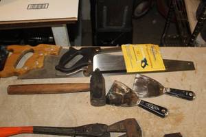 lot 554 image: Lot of (9) Hand Tools - Hand Saws, Mallet, Sleeve Tool, Mud Knives, Hatchet, Fiskars Bypass Loppers, Bolt Cutters