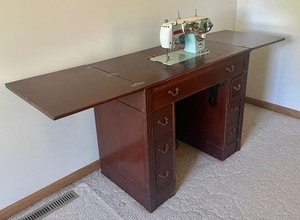 lot 134 image: Vintage Sewing Table with a Holiday Sewing Machine and Notions