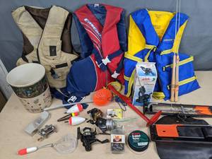 lot 415 image: Fishing Supplies Life Vest, Bobbers, Fishing Reels, Fishing Net, Berkley Braided Nylon Fishing Line, Rod Tender, Rubber Grips and More X