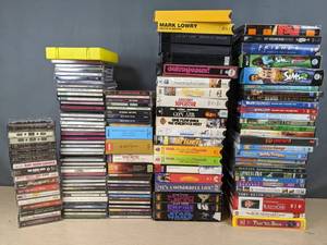 lot 416 image: Large Assortment of DVDs, VHS, CDs and Tapes Everybody Loves Raymond, The Peacemaker, Curious George, The Sims 2, The Very Best of Cher, Elton John, Keith Urban, Nitty Gritty Dirt Band and More X