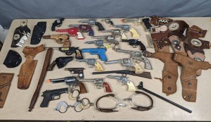 lot 418 image: Assortment of Toy Gun Replicas, Holsters, Spurs, Handcuffs and More X