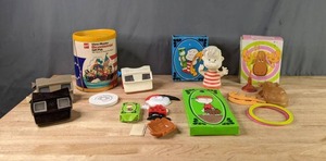 lot 450 image: (4) Vintage View Master Toys, Vintage Charlie Brown Soap Holder, Vintage Linus Gel Bubble Bath Holder, Vintage Loop-a-moose Game, View Master Gift Pack  X