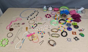 lot 595 image: Assortment of Kids Costume Jewelry, Beyblade Pieces & Parts, Eeyore Watch, Hair Accessories, and More  Z